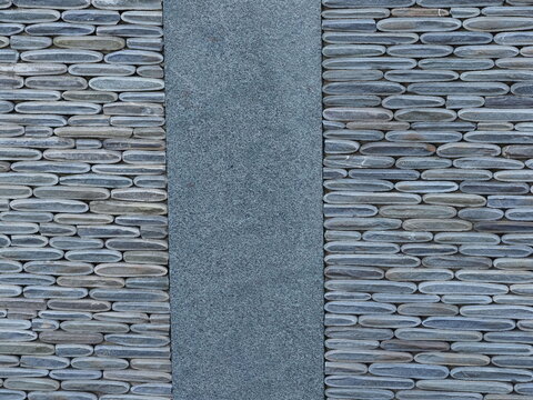 Texture of a fence made of decorative stonework made of gray sea pebbles