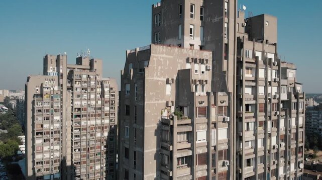 Aerial drone shot tilting up on brutalist architecture and residential apartment buildings in Belgrade Serbia