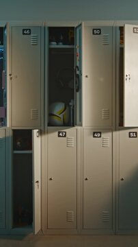 School Hallway Lined With Metal Lockers Before Students Arrive, Capturing Calm Atmosphere of New School Day. Modern Educational Interior With Copy Space, Learning, and Campus Lifestyle. Vertical Shot.