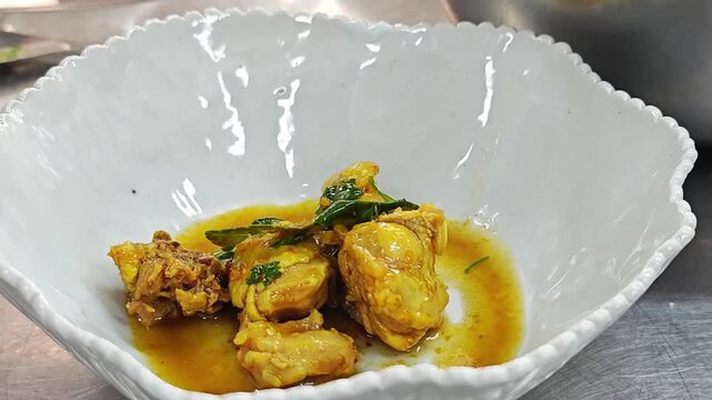 Thai yellow chicken curry serving with a ladle.