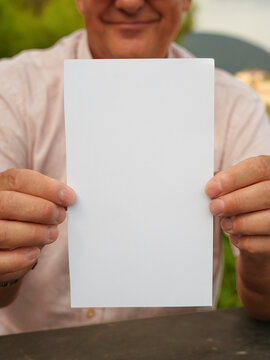Person Holding Blank Sign Outdoors with Copy Space