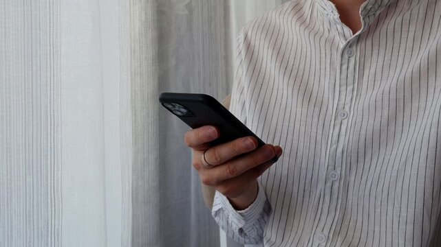 Man using smartphone to check messages, notifications and social media for online communication, mobile internet and digital connectivity