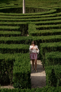 Woman Enjoying a Day in a Park Maze
