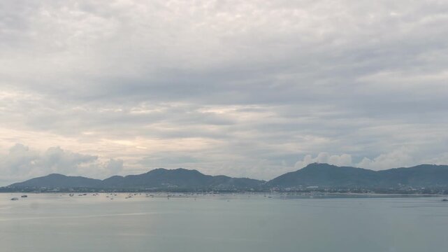
time lapse cloudy sky above the mountain range.
At Khao Khad viewpoint you can see around Ao Chalong gulf. 
Phuket big Buddha on the mountain backgroud.