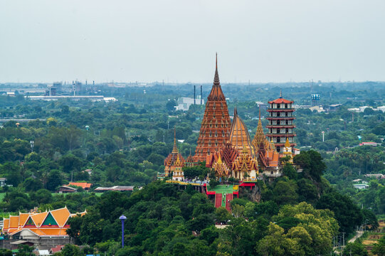 Landscape of Wat Tham Sua Temple (Tiger Cave Temple) in Sunset scence with Jasmine rice fields at Kanchanaburi Province, Thailand. Is an important landmark that everyone must visit