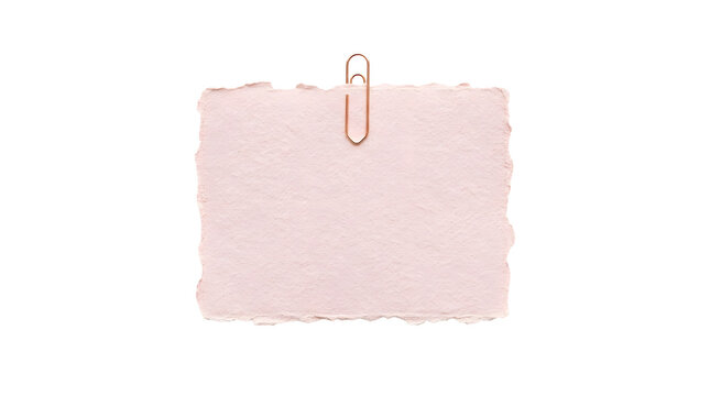 Pink handmade paper sheet pinned with copper clip for design.