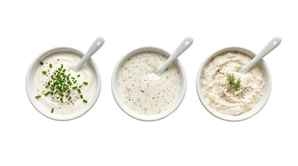 Three bowls of white creamy dips with herbs for food styling.