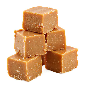 Dulce leche fudge squares of Dominican milk candy stacked on a transparent background showing characteristic grainy texture