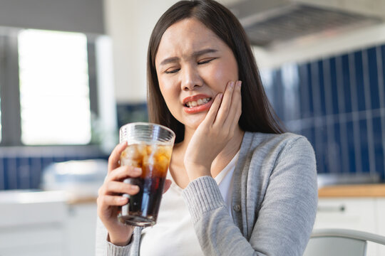 Close-up woman touching her cheek feeling sensitive teeth