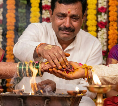 Father Crying While Performing Hindu Wedding Ritual with Bride a