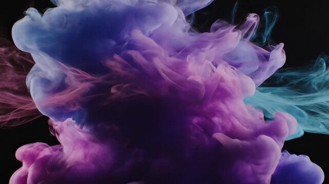 Pink and blue smoke mix together in a dark space creating interesting shapes. The smoke flows smoothly and changes as it moves