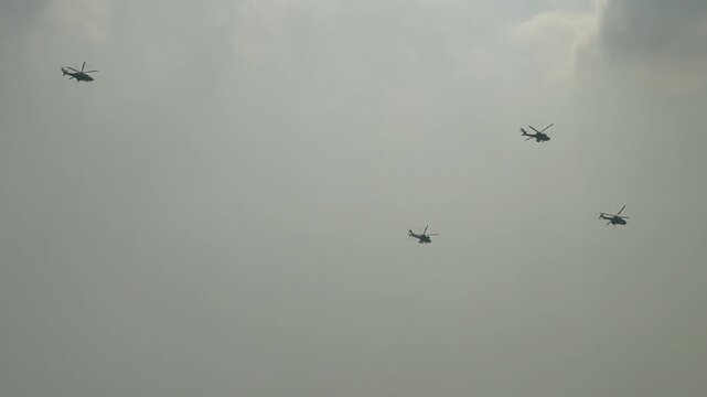 Three helicopters flight in cloudy sky during daytime capturing aerial transportation or outdoor exploration activities for travel or safety campaign visuals