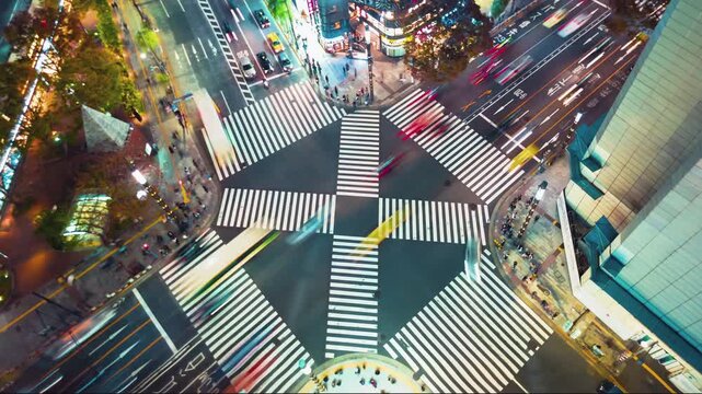 Tokyo Intersection at Night Aerial View Showing Heavy Vehicle Light Trails and Pedestrian Movement in a Busy Urban Cityscape Timelapse 4k High Resolution Footage