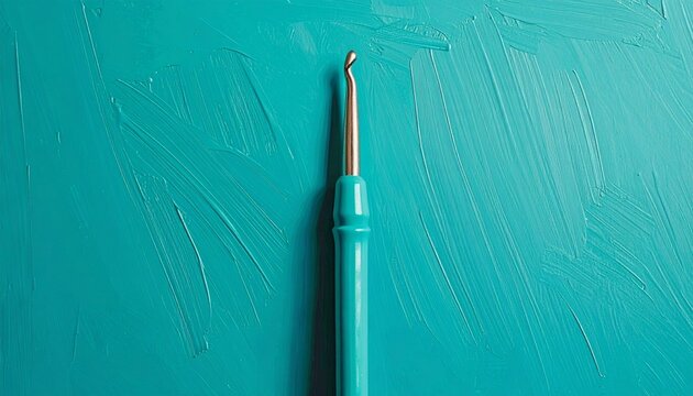 Close up of a surgical needle holder on teal background.