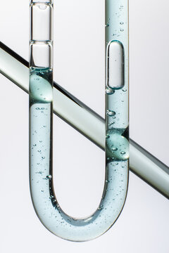 Vertical Macro View of Glass Laboratory Tube with Blue Serum