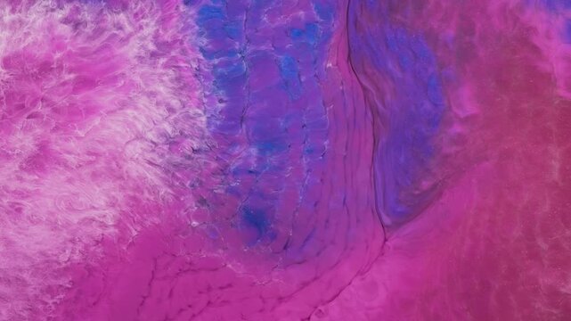 Mixing different colored alcohol inks to create unique patterns