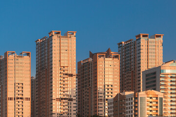 Fototapeta premium New Residential Multi-storey Houses. Cityscape Skyline In Sunny Spring Evening On Blue Sky. Real Estate, Development Industry. UAE