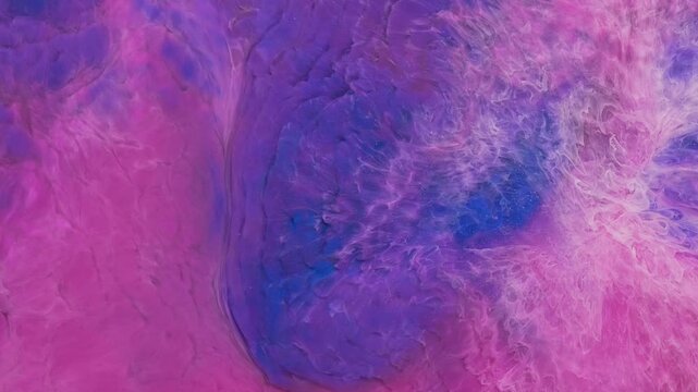 Mixing different colored alcohol inks creates abstract patterns in art