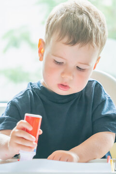 Young child discovering the joy of art through spontaneous creative play.