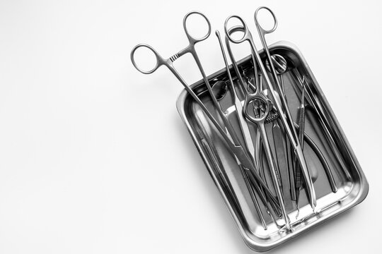 Sterile surgical instruments and tools - scalpels, scissors and others - in a stainless tray, top view