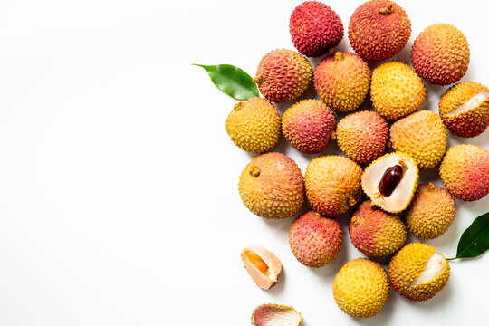 Exotic lychee fruit with green leaves, top view. Healthy vegetarian meal