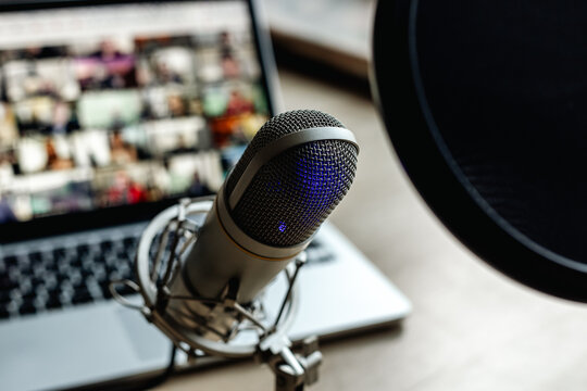 On the air concept - microphone with filter and laptop computer. Podcast recording