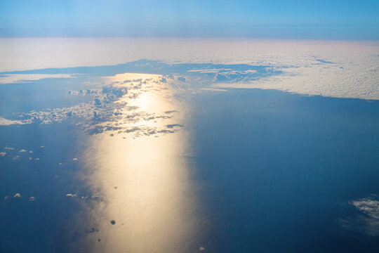 Aerial Sun Reflection On Ocean Through Clouds