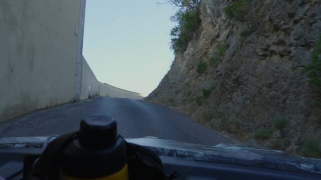 POV buggy ride along a winding road through coastal hills