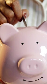 Indian Asian couple in their fifties with grey hair, sitting on the sofa holding a piggy bank, surprised as five-hundred rupee notes rain down, symbolizing returns on savings