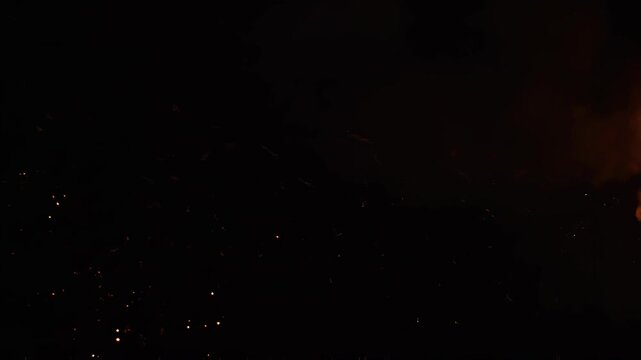 Fiery projectile with particles exploding in darkness during cinematic motion