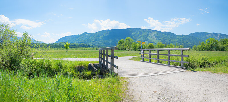 Hiking trail junction with a bridge over the Lindenbach cree,.Murnauer Moos natural landscape.