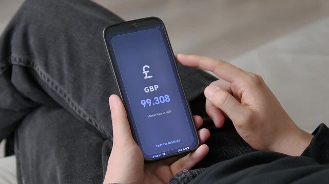 Smartphone displays British pound exchange rate against global currencies, representing digital finance, currency markets, international economy and modern mobile banking technology.