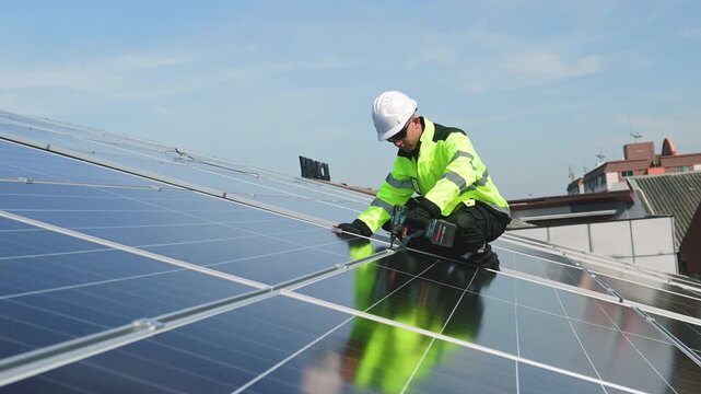 Technician installing rooftop solar panels for green energy, supporting renewable energy, clean power, sustainable technology and solar infrastructure.