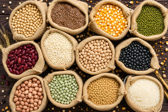 ​Assorted grains, beans, and seeds in small burlap sacks top view