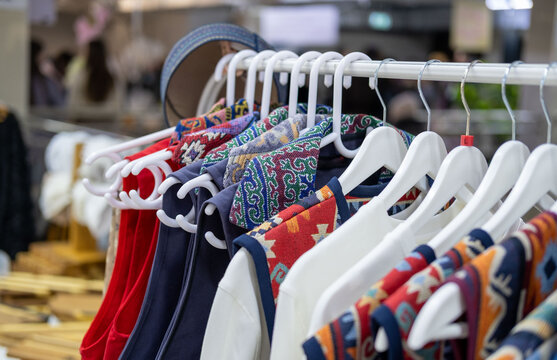 Modern clothing inspired by Kazakh asian traditional culture, featuring ethnic patterns, colorful garments and a traditional Kazakh skullcap in a contemporary fashion setting.