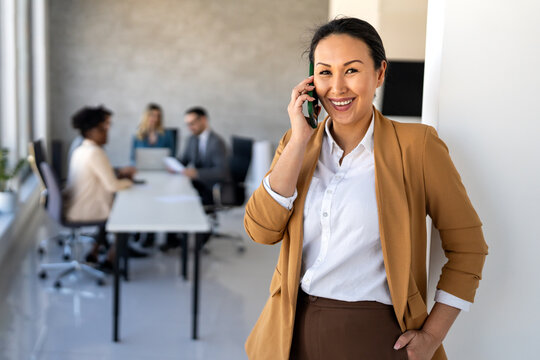 Smiling successful business woman, freelancer, coworker female leader using digital device, phone