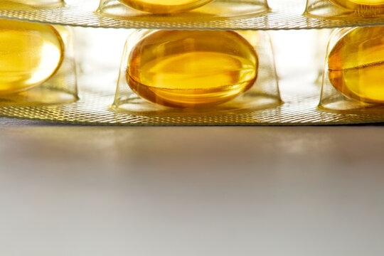 Yellow softgel capsules in blister pack macro shot