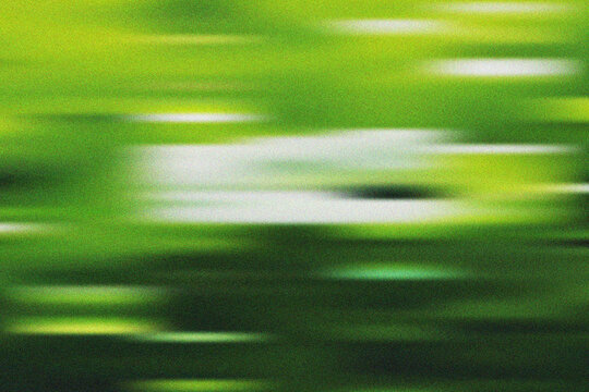 Abstract green and white horizontal motion blur effect with grain providing a textured dynamic visual
