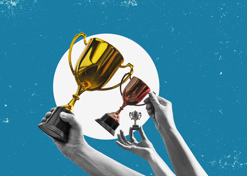 Flat-design illustration. Hands hold up various trophies - small, medium, and large against a simple background. A concept representing awards, victory, and competition.