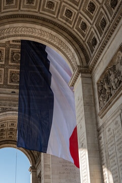 Paris, France: Arc de Triomphe in Paris with a big French flag under it