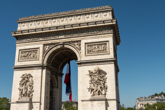 Paris, France: Arc de Triomphe in Paris with a big French flag under it