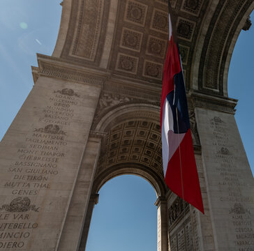 Paris, France: Arc de Triomphe in Paris with a big French flag under it