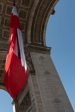 Paris, France: Arc de Triomphe in Paris with a big French flag under it