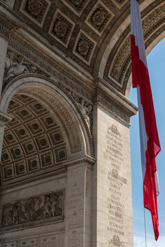 Paris, France: Arc de Triomphe in Paris with a big French flag under it