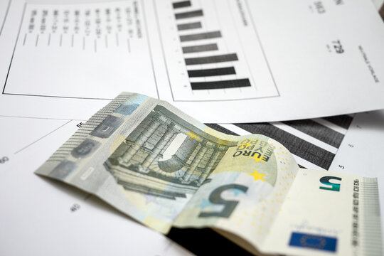 Documents and money are placed on a table during an office work session in a business environment