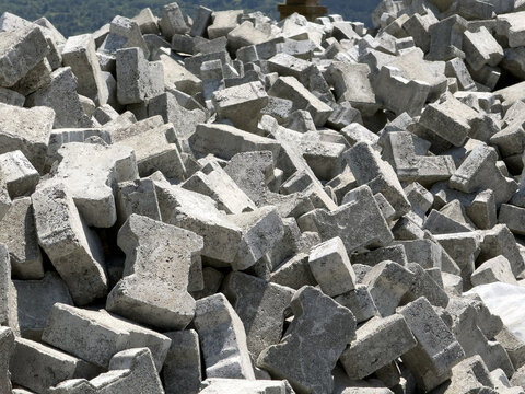 View of a large pile of grey interlocking concrete paving stones stacked outdoors in Posof, Ardahan, Turkiye.