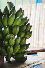 Fresh green bananas on the dark background © Thai