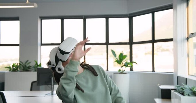 Nonbinary African in green top donning white VR headset, exploring scene in office with plant