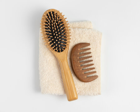 Eco friendly hair care products mockup with bamboo brush and comb on towel