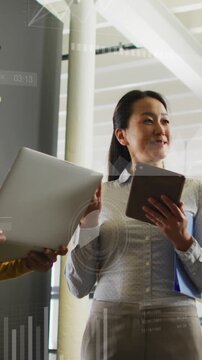 Animation of graphs, numbers, loading circles, bars, diverse female coworkers discussing in office